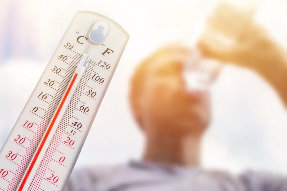 Man drinking water in extreme heat.