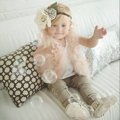 toddler's hairstyle with a flower