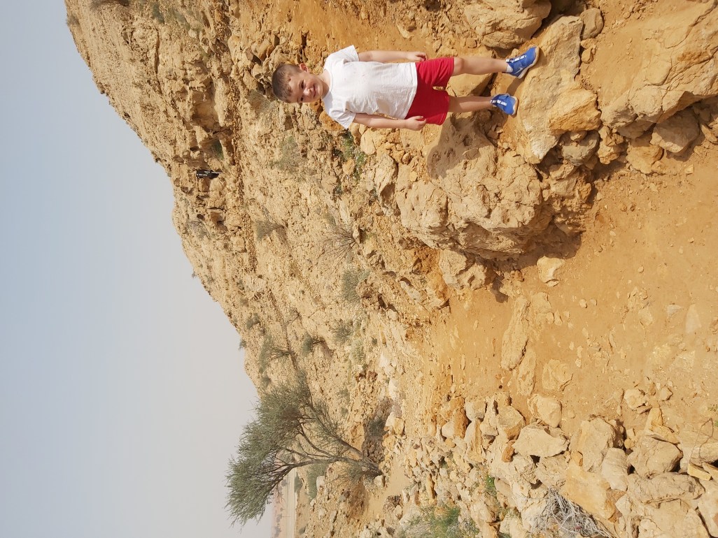 Boy smiling on a hike.