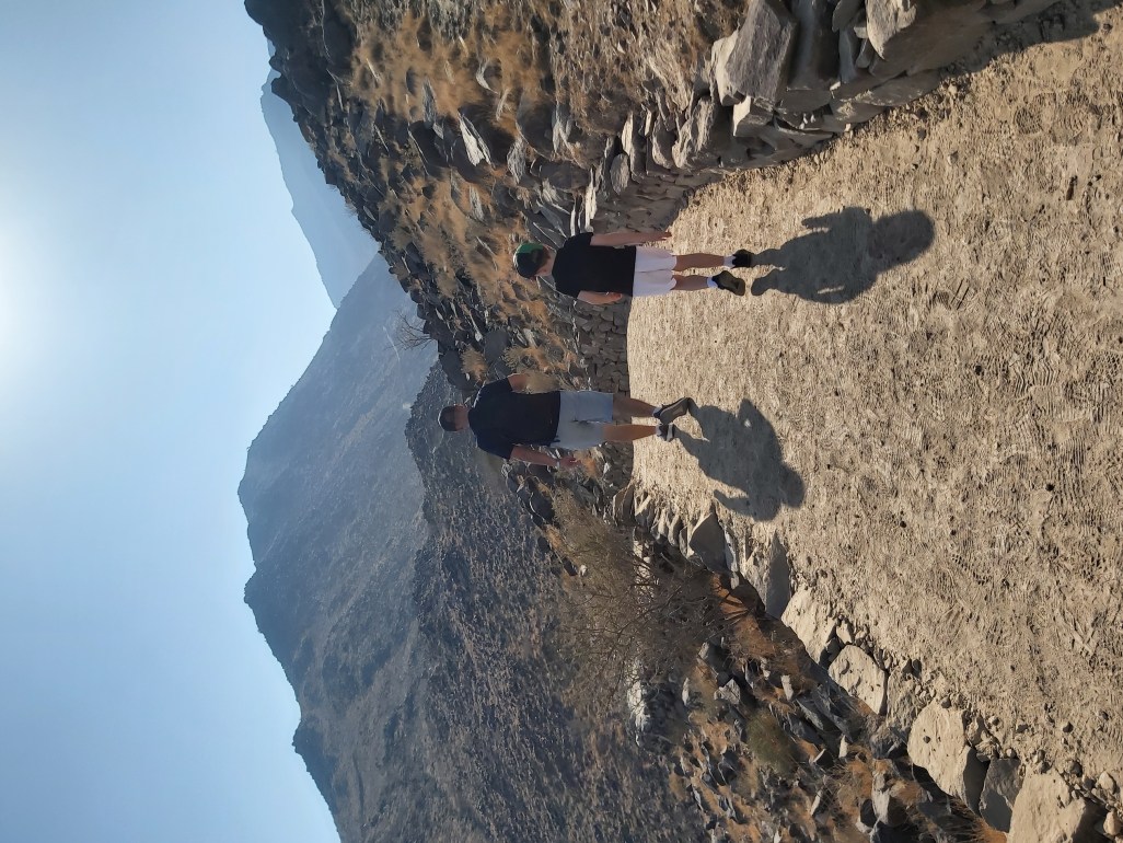 Dad and son walking on a family hike in UAE.