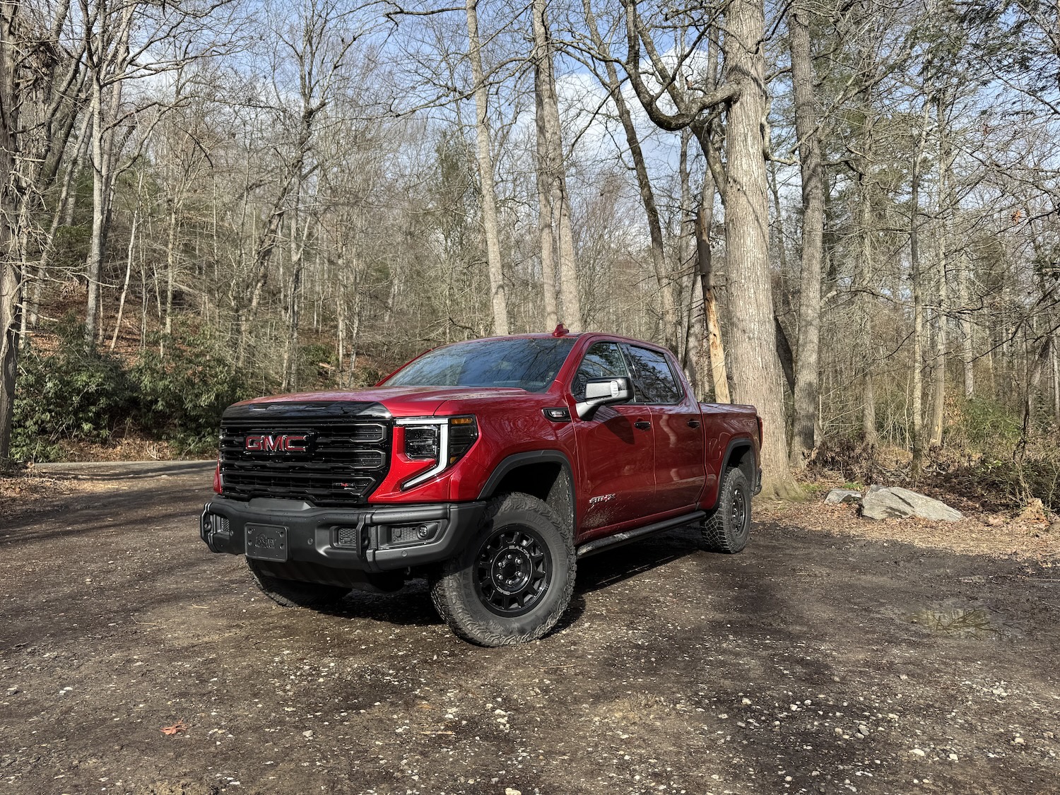 The 2025 GMC Sierra 1500 AT4X AEV Edition off-roading in the woods 