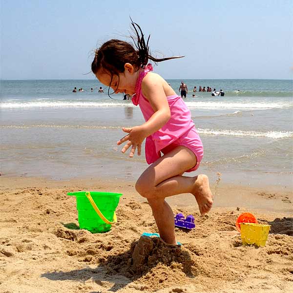 This child having is fun on the beach in ocean city.