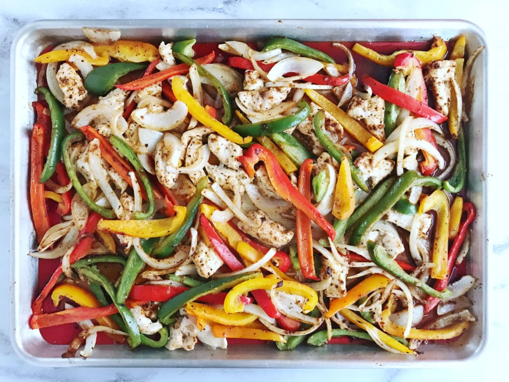 These easy Sheet Pan Chicken Fajitas are an easy weeknight dinner. Dress them up with your choice of toppings for a flavorful and filling meal! | recipe via www.yourchoicenutrition.com