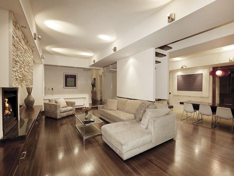 Open plan living room using white colours with floorboards & bi-fold ...