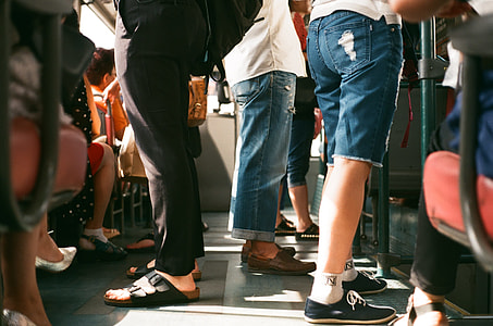 shallow focus photography of group of people riding on transport bus