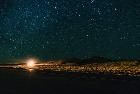 mountain under starry sky during nighttime