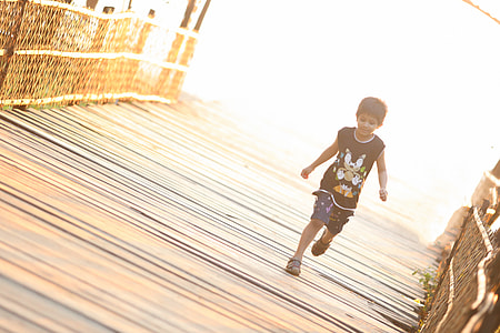 boy in black tank top running