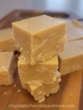 several squares of peanut butter fudge stacked up on a cutting board