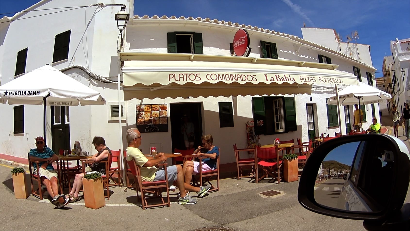 Tourist eating on a restaurant terrace in Fornells