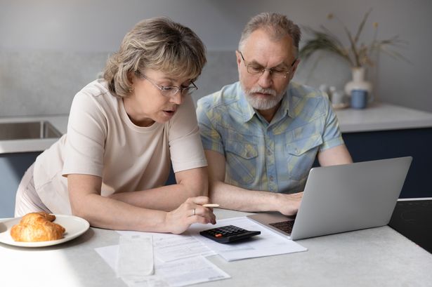 A pensioner couple looking at their finances