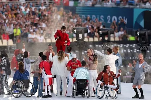 Christine and The Queens performing at the Paralympics opening ceremony surrounded by disabled dancers