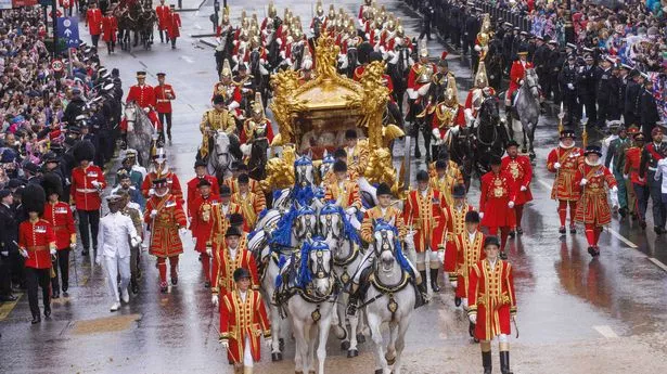 King Charles III and Queen Camilla, travel from Westminster Abbey in the Gold State Coach to Buckingham Palace after the Coronation where Charles became King Charles III