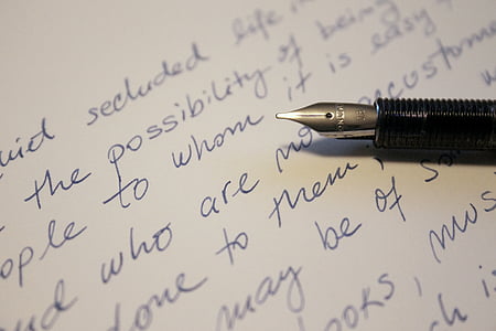 black fountain pen on top of white textile