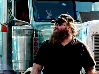 man standing in front of freight truck