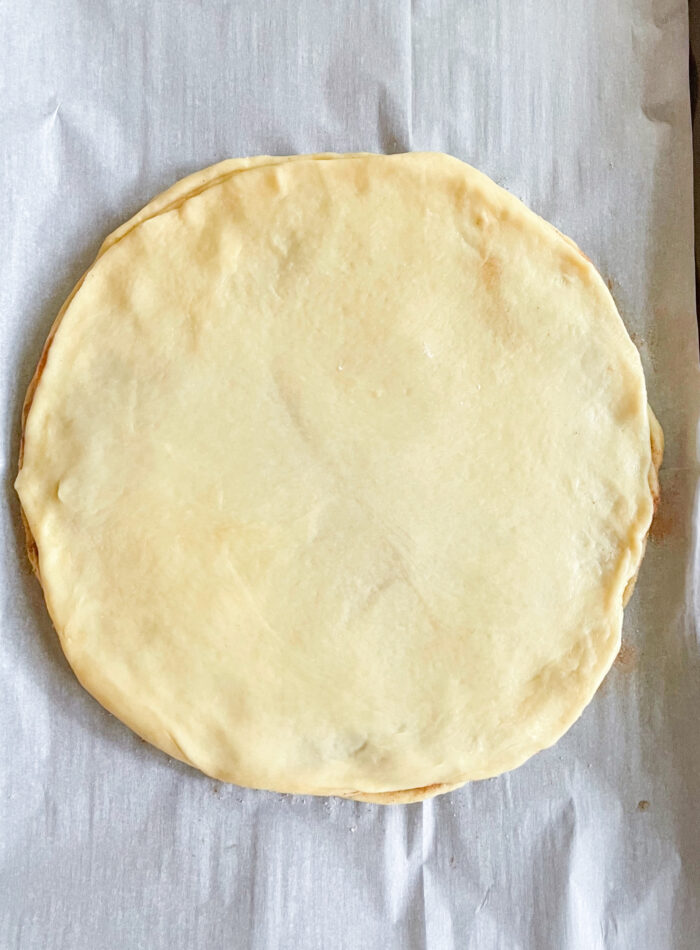 another dough circle topped over the first dough circle