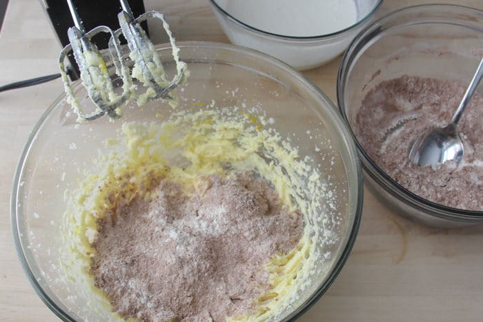 Adding a small amount of the dry ingredients into the egg/butter/sugar mixture