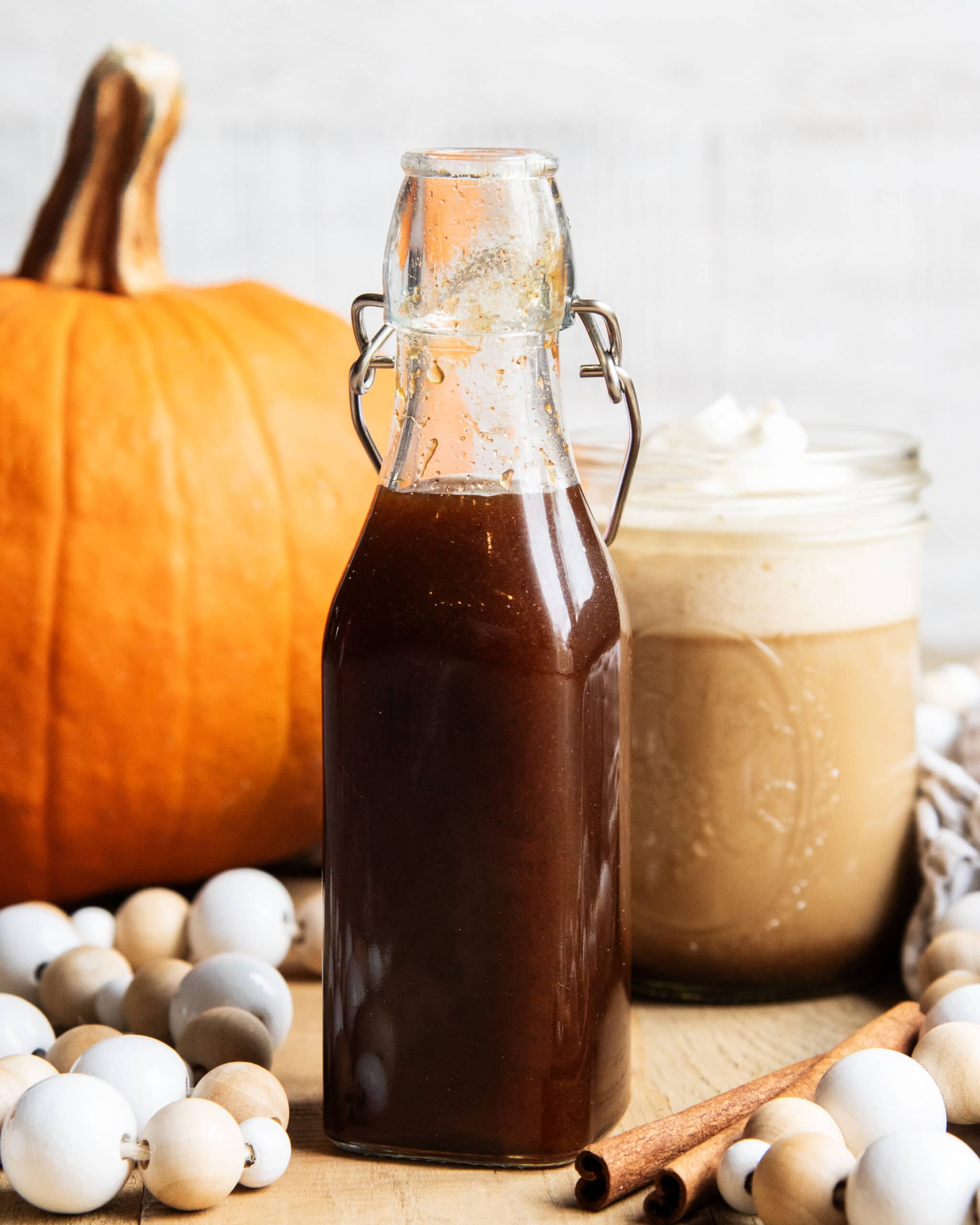 A glass bottle of homemade pumpkin spice syrup.