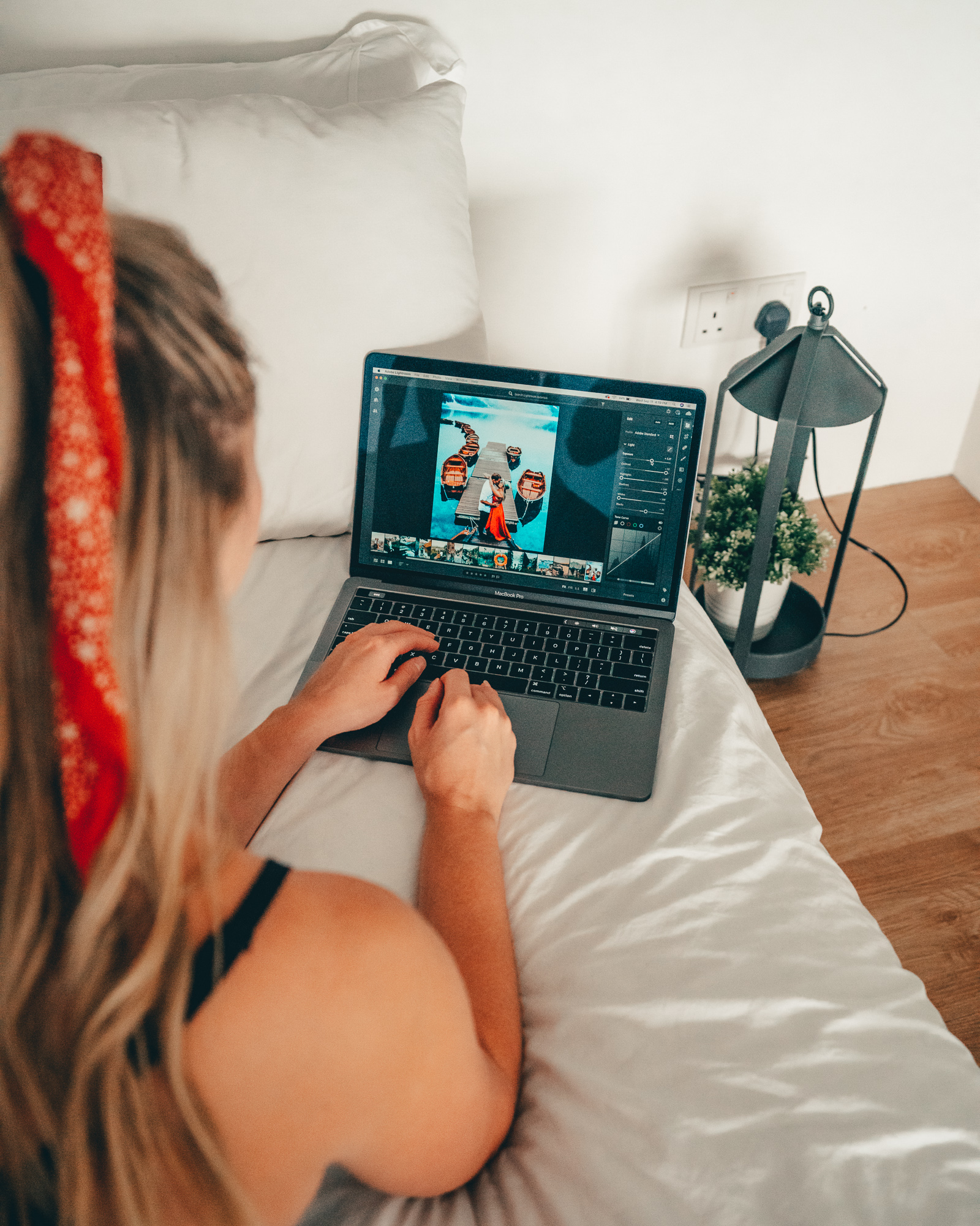 Kylie editing travel photos on a MacBook pro using Lightroom CC