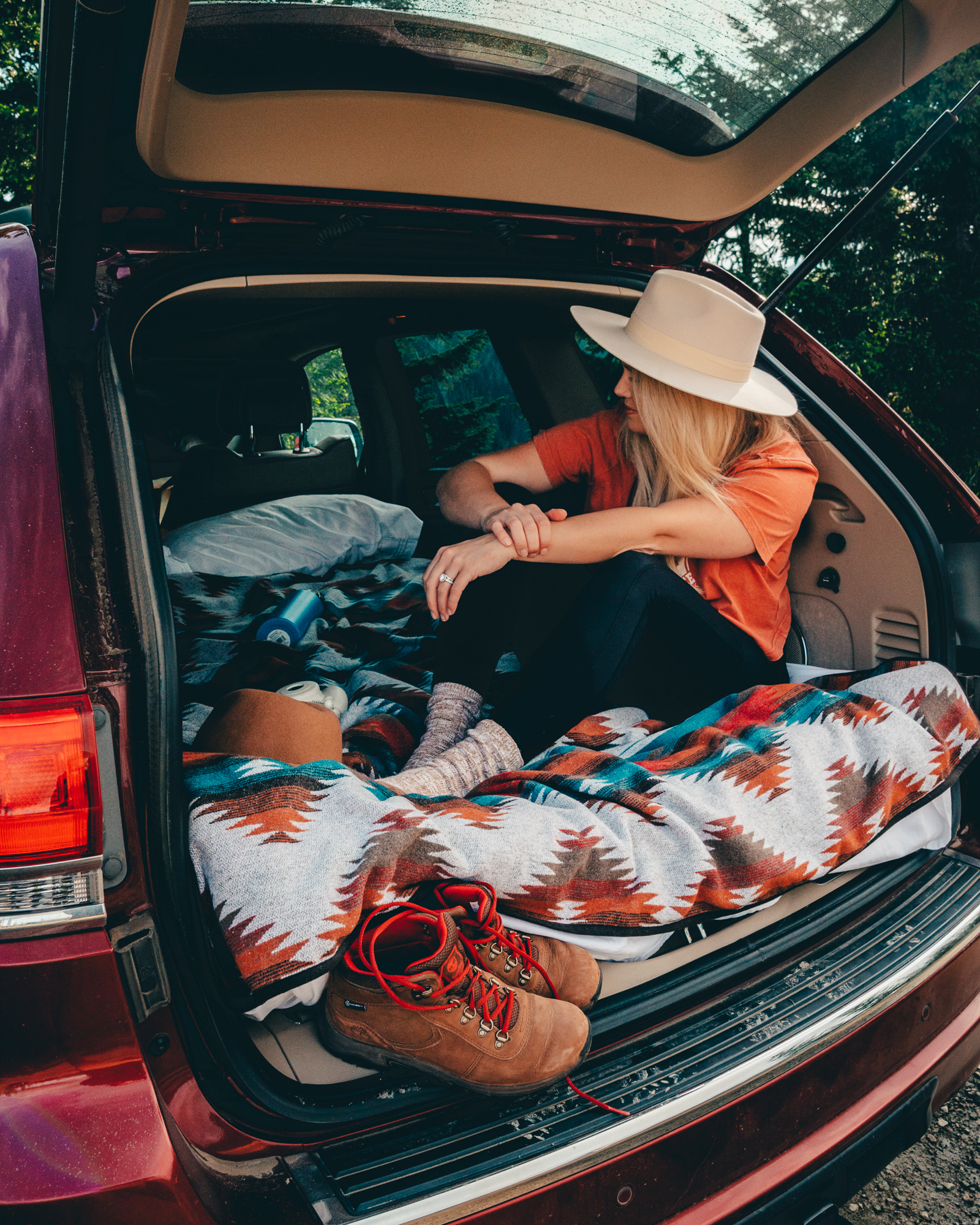 Sitting in the back of the trunk during a car camping adventure