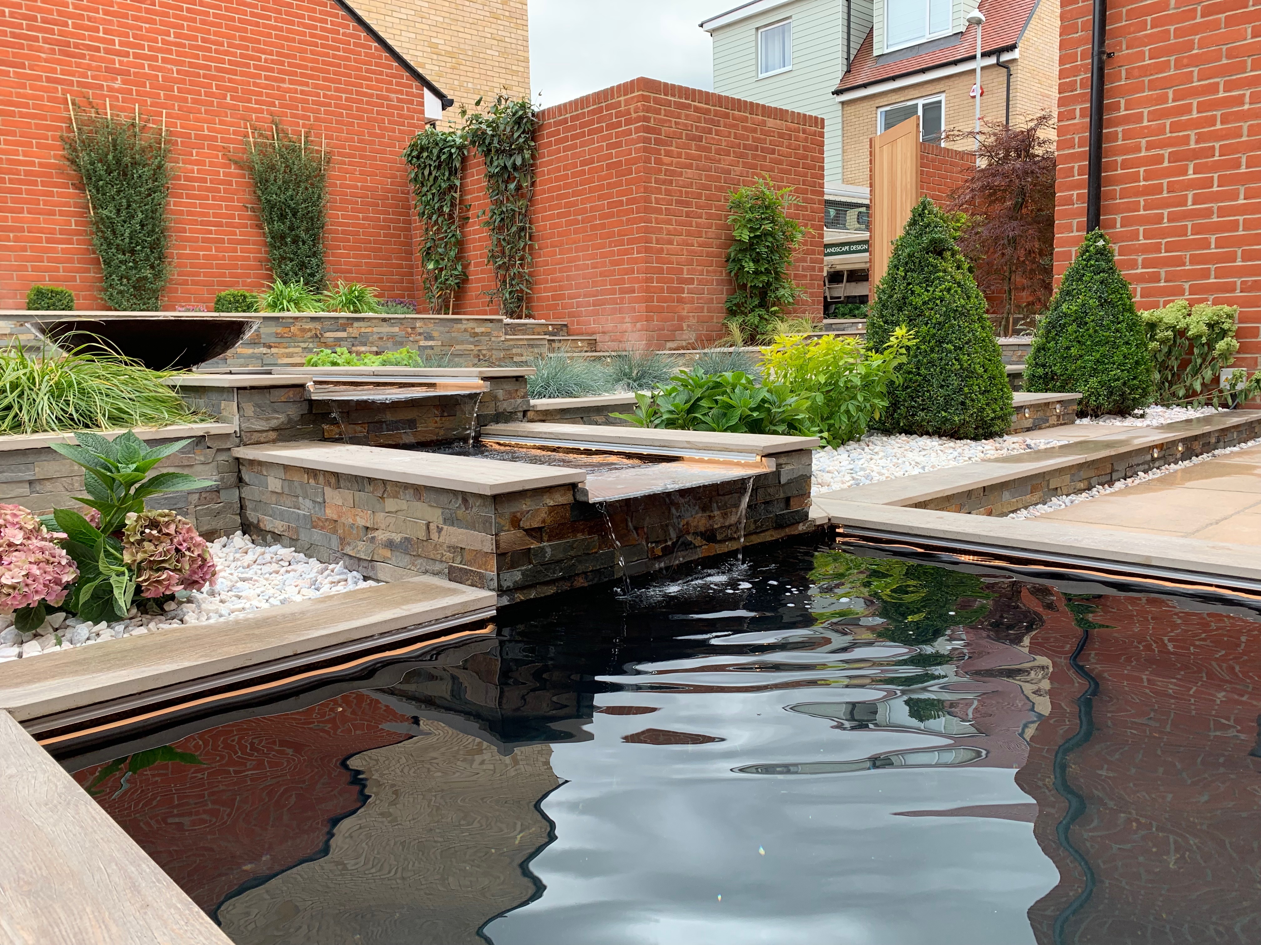 An elegant patio with a water feature Marshalls