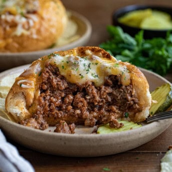 Bread Bowl Sloppy Joes cut in half showing inside filled with sloppy joe.