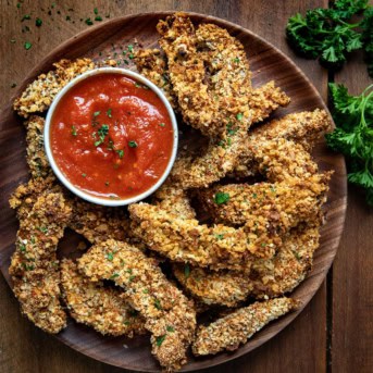 Plate of Portobello Mushroom Fries on a wooden table from overhead.