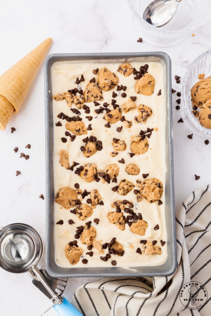 a loaf pan viewed from above, filled with homemade cookie dough ice cream with chocolate chips.