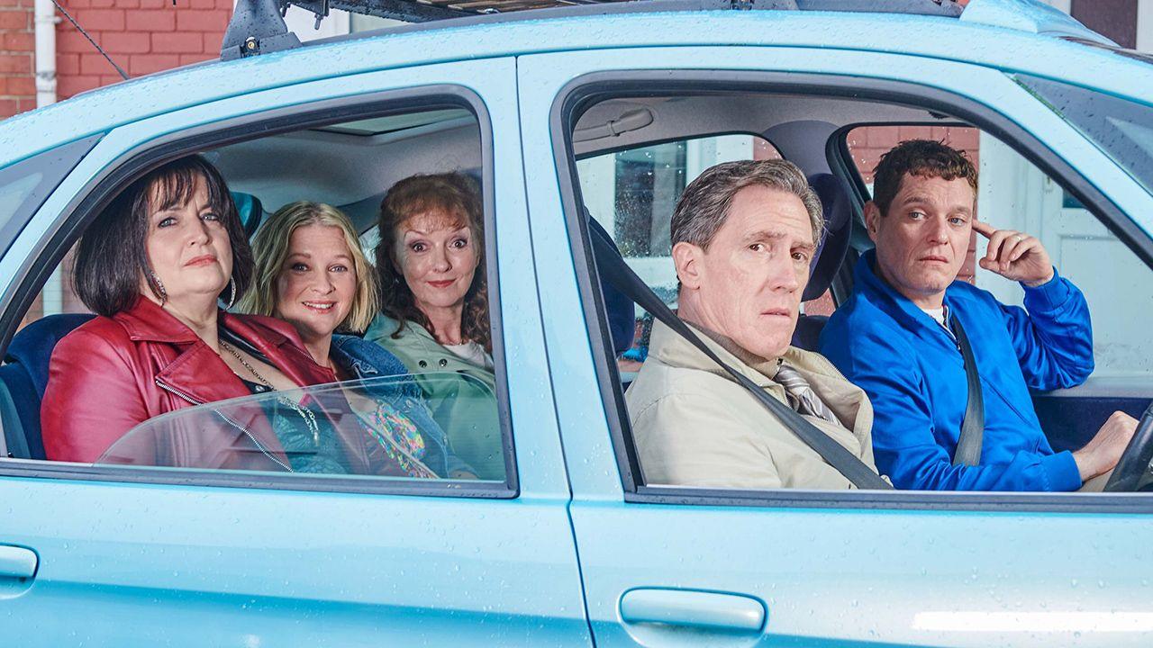 The cast of Gavin and Stacey sit in a blue car and look at the camera, posing as their characters, in a promo photo for the series