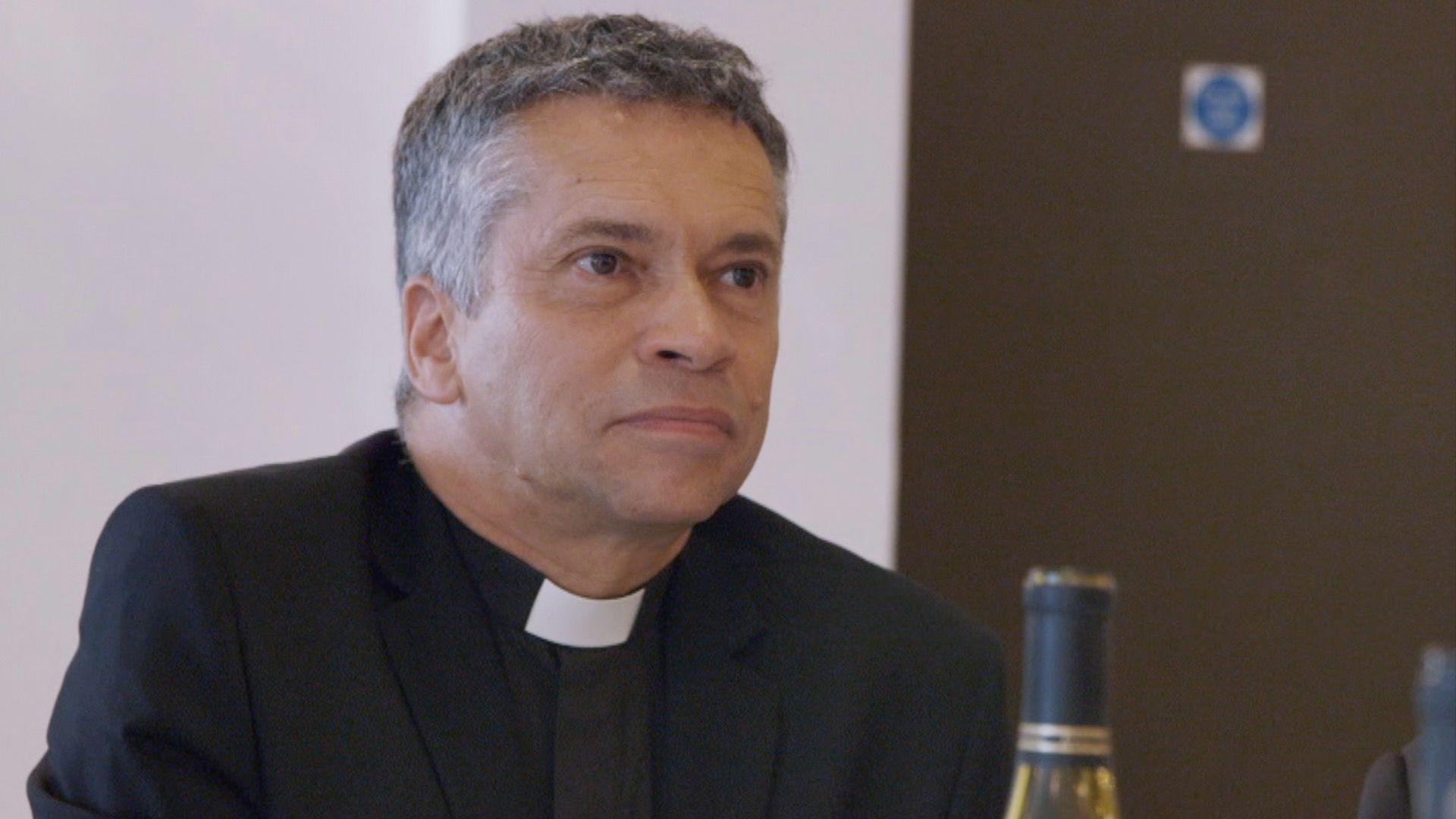 David Tudor, a vicar on Canvey Island, pictured taking part in a BBC documentary in 2018. He appears in a black suit with a white dog collar, with greying hair.