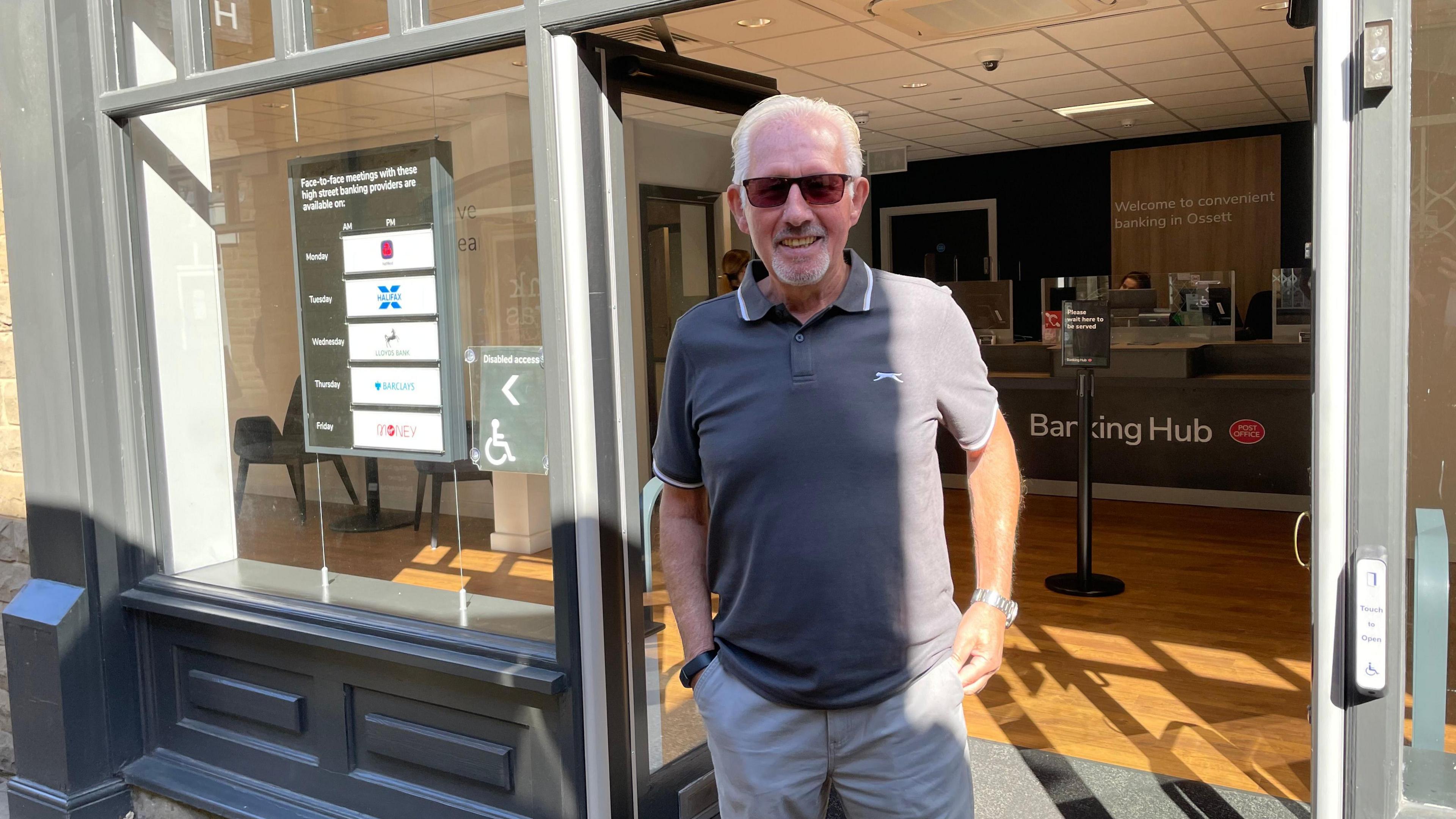 Brian Good, standing outside the banking hub