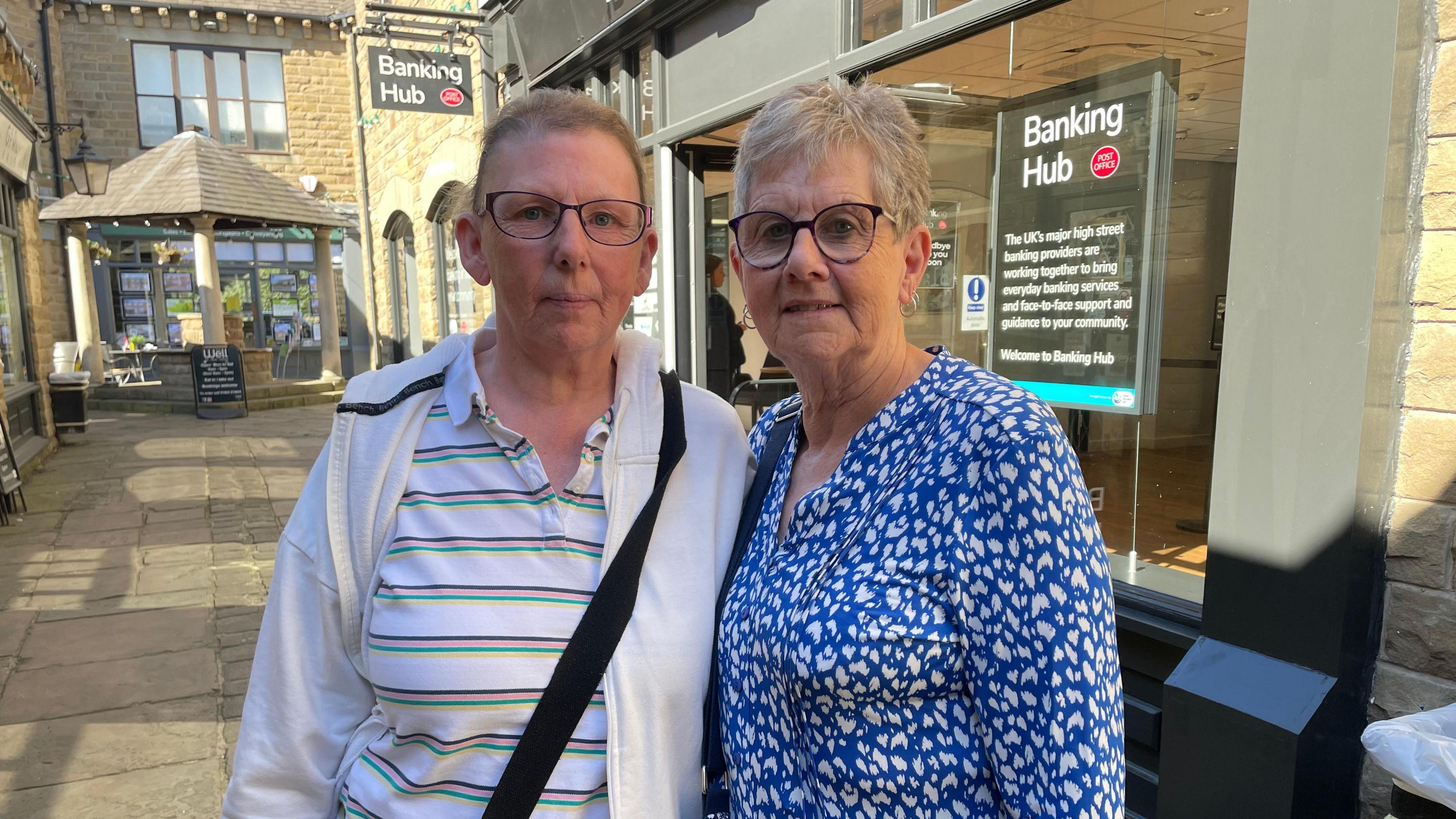 Sharon Petre and Barbara Dunford, outside the banking hub.