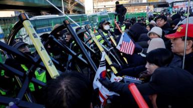 Yoon Suk Yeol's supporters scuffle with police officers as authorities seek to execute an arrest warrant on Wednesday morning.