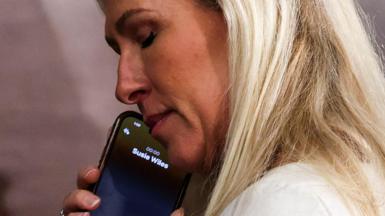 Marjorie Taylor Greene talks on the phone as the House votes for a Speaker of the House on the first day of the 119th Congress on 03 January, 2025