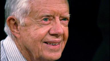 Jimmy Carter smiles into the distance in his old age.