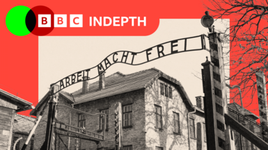 Black and white image of the gates to Auschwitz with the sign: "Arbeit Macht Frei."