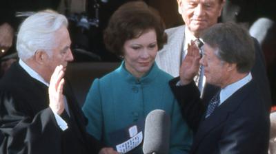 Jimmy Carter raises his hand to take the oath at his inauguration ceremony in 1977