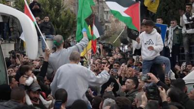 Crowd waving Palestinian flag 