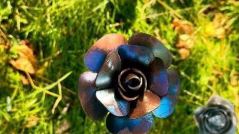 Rose made of steel on grass