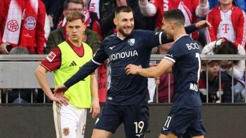 Matus Bero of Bochum celebrates scoring his team's third goal with teammate Giorgos Masouras 