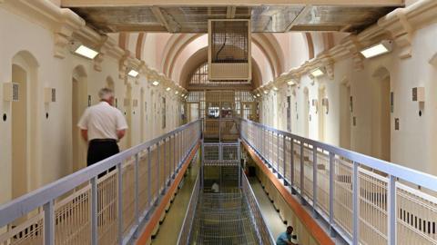 A prison officer walks down the C wing at Wandsworth prison in South West London.