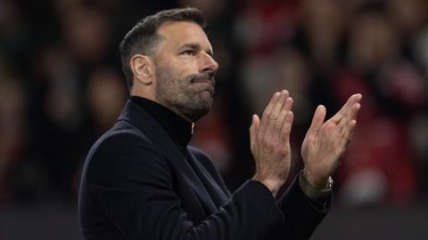 Manchester United interim manager Ruud van Nistelrooy applauds the fans