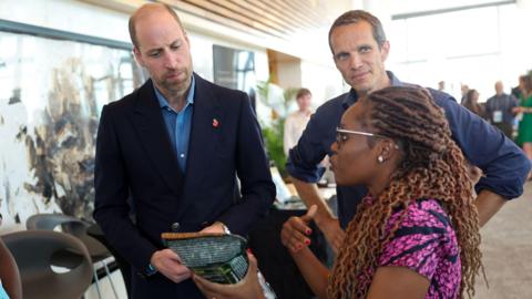 The Prince of Wales meeting a local businesswoman in Cape Town