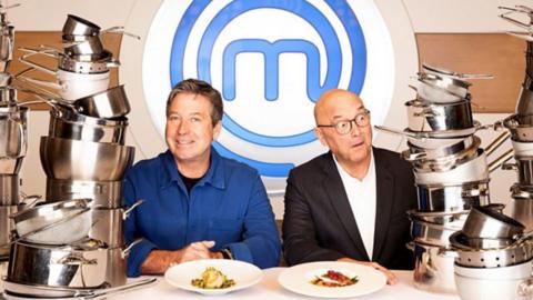 MasterChef judges John Torode and Gregg Wallace surrounded by pots and pans