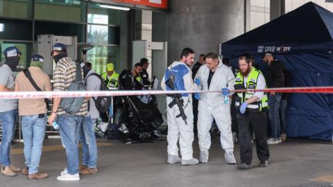 Israeli police and forensic investigators work at the site of a deadly stabbing attack in Haifa, northern Israel (3 March 2025)