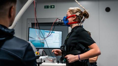 A girl runs on a treadmill while taking part in a VO2 Max test