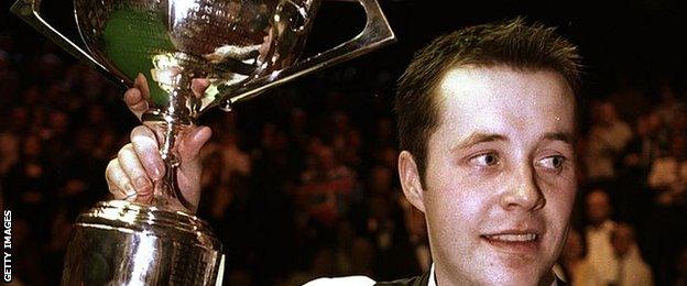 John Higgins in 1998 with the first of his four World Championship trophy wins