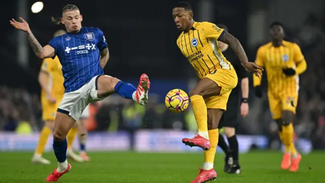 Kalvin Phillips of Ipswich Town is challenged by Pervis Estupinan of Brighton