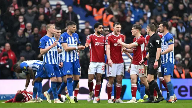 Brighton and Nottingham Forest players confront referee Michael Salisbury