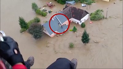 Circle around man stranded on roof waving to firefighters