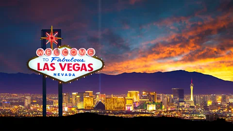 A welcome to Las Vegas sign is shown in front of the city skyline (Credit: Getty Images)